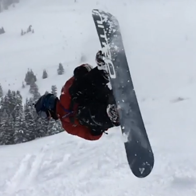 Levi Smith doing a flip on a snowboard